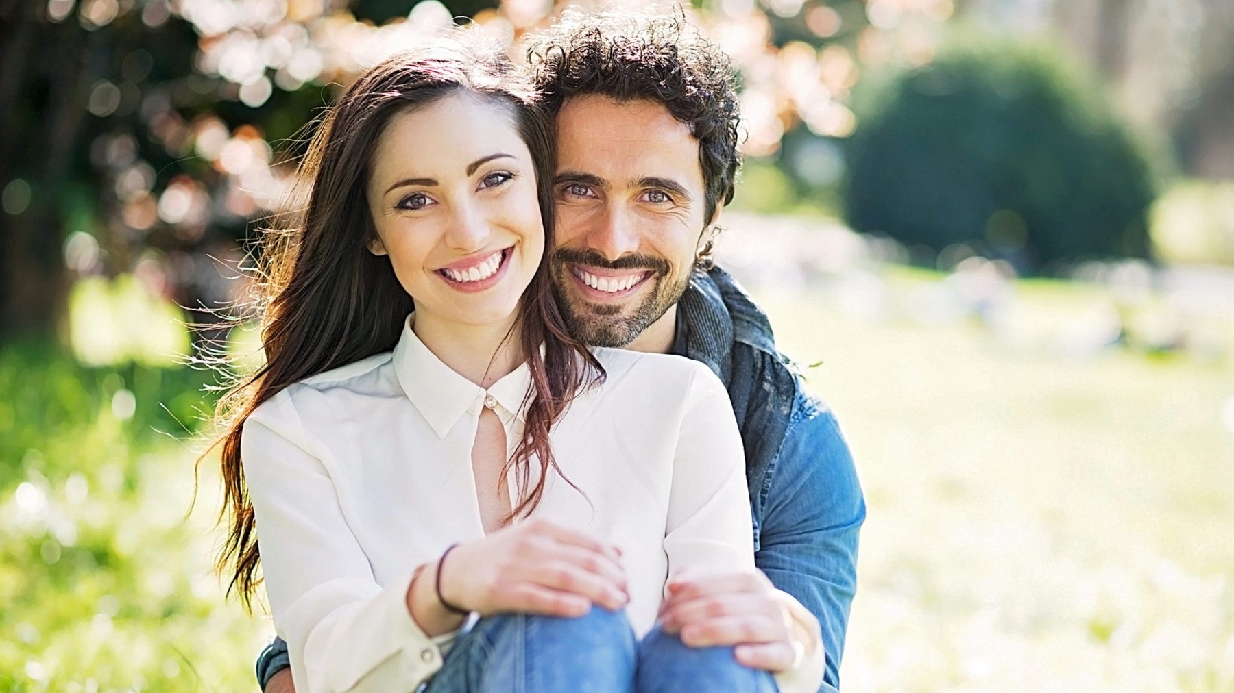 A couple sitting together outdoors